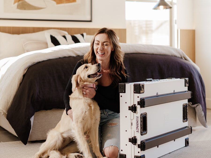 Smiling woman with a Golden Retriever next to a durable dog crate in a stylish bedroom.