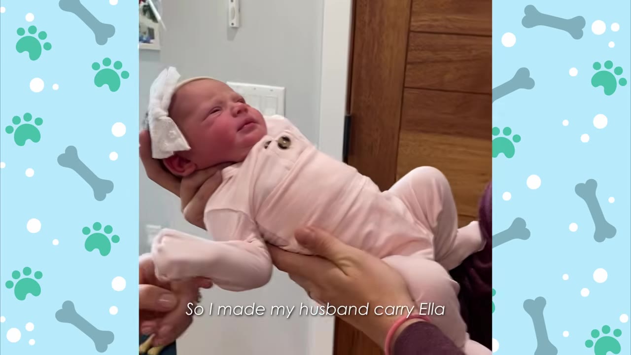A newborn baby wearing a pink outfit and a white bow headband is held in someone's hands.