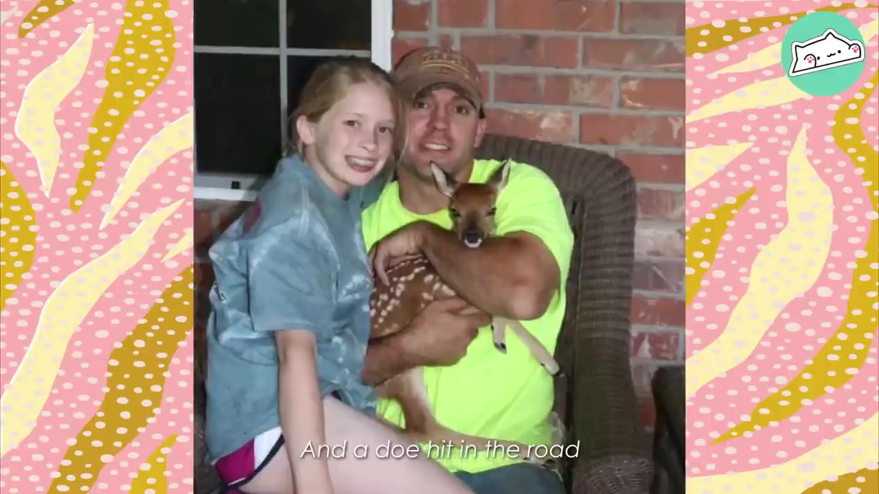 A man in a neon yellow shirt and a young girl sit together on a porch chair, with the man holding a small, spotted baby fawn in his arms.