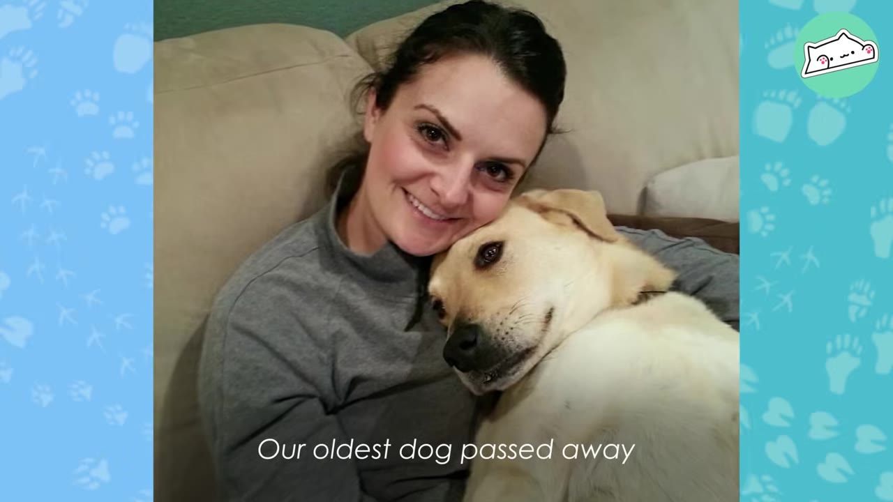 A woman smiles as she cuddles on a couch with a light-colored dog resting its head against hers.