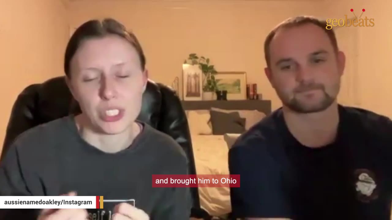 A woman and a man sit side-by-side in a room, speaking to the camera with a subtitle that reads 'and brought him to Ohio'.
