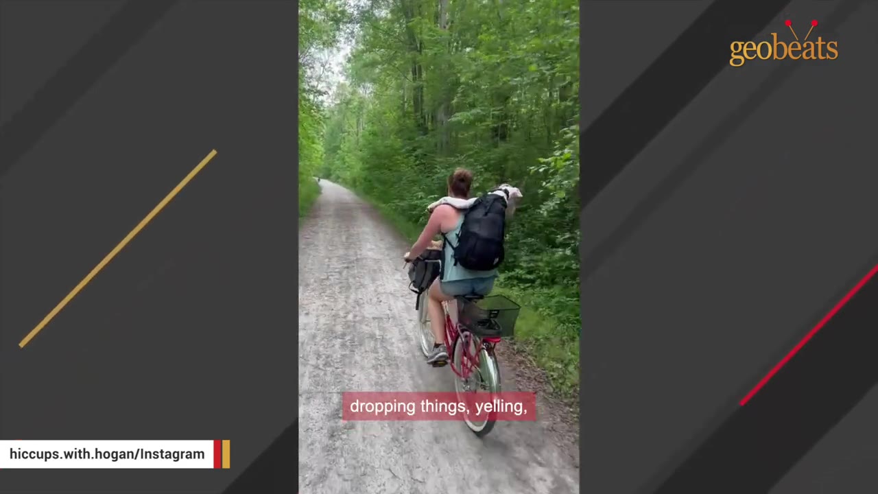 A person riding a bicycle on a wooded path with a white dog in a backpack, with a subtitle that reads 'dropping things, yelling,'.