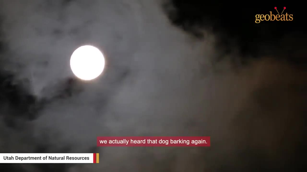 A bright full moon shining through dark, cloudy night skies.