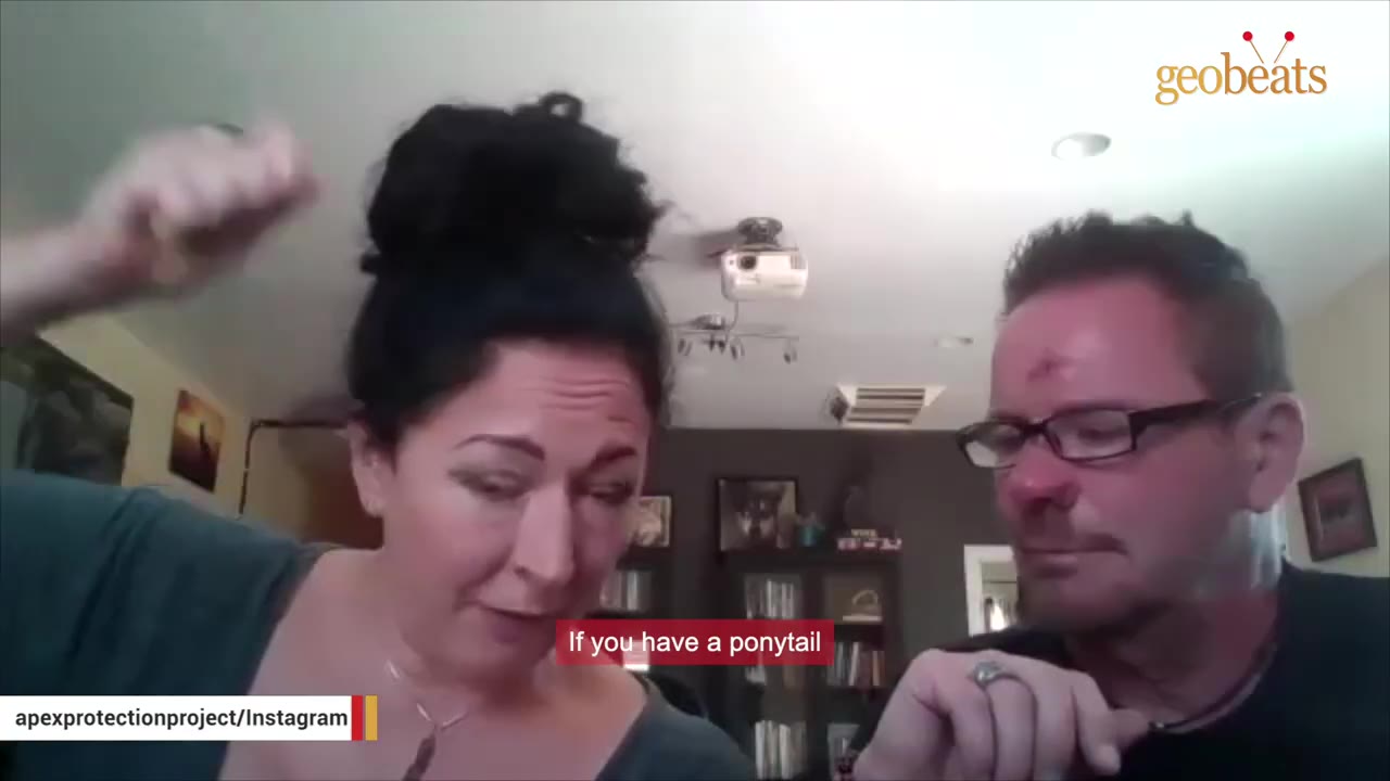 A woman with her hair in a high bun gestures to her head while speaking next to a man wearing glasses, with a subtitle reading 'If you have a ponytail'.