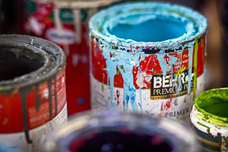 Paint and Wood Stain in Half-Closed Cans