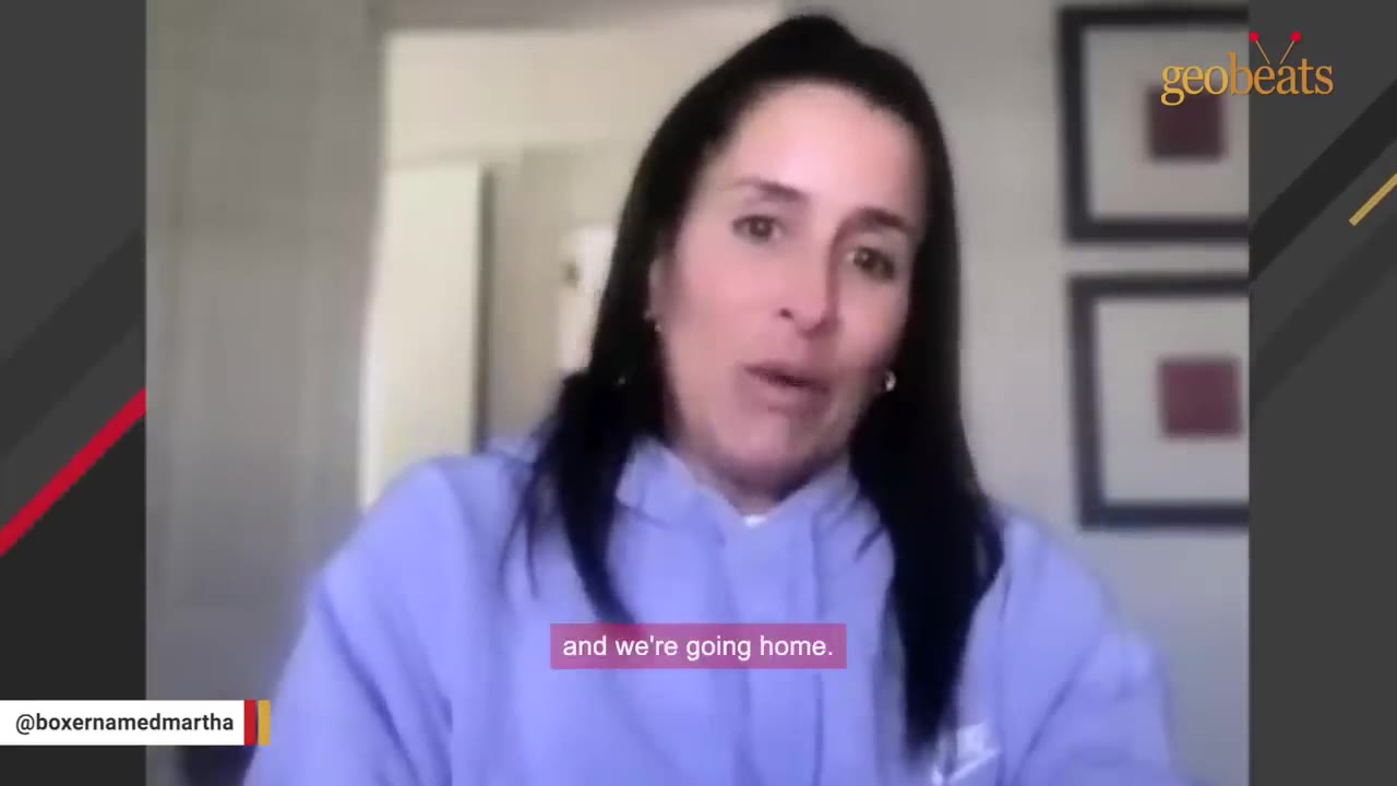 A woman in a light blue hoodie speaking to the camera with a subtitle that reads 'and we're going home.'