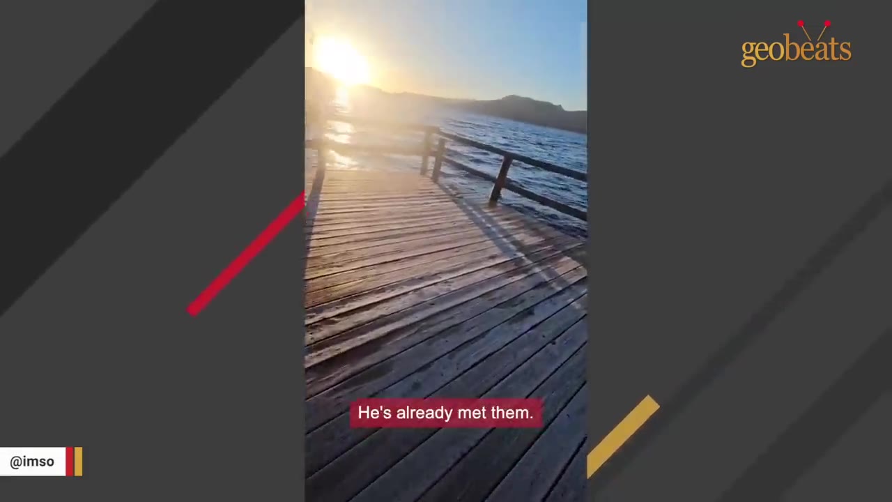 A wooden dock extending into a body of water under a bright sunset.