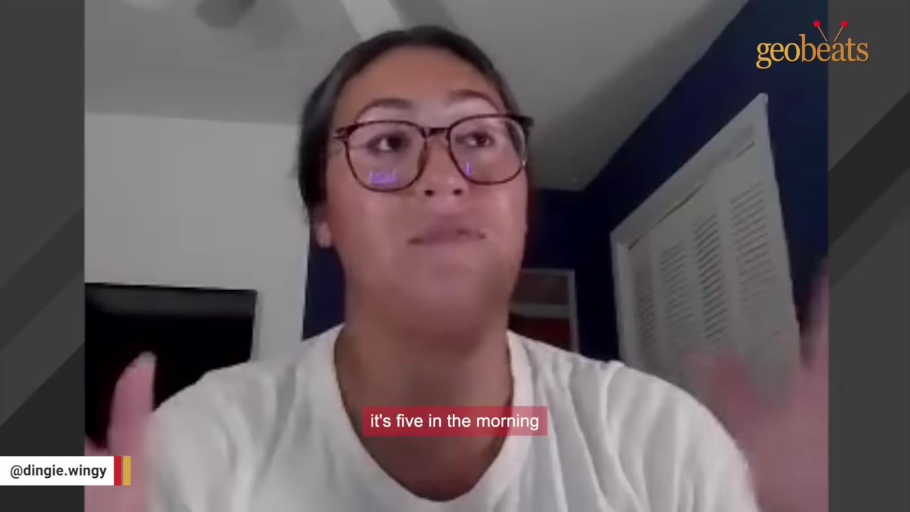 A woman with glasses and a white shirt speaking, with a subtitle that reads 'it's five in the morning'.