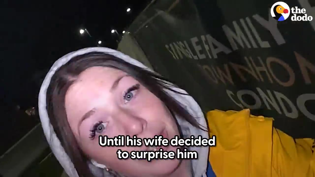 A close-up selfie of a woman wearing a light gray hoodie and a yellow jacket outdoor at night.