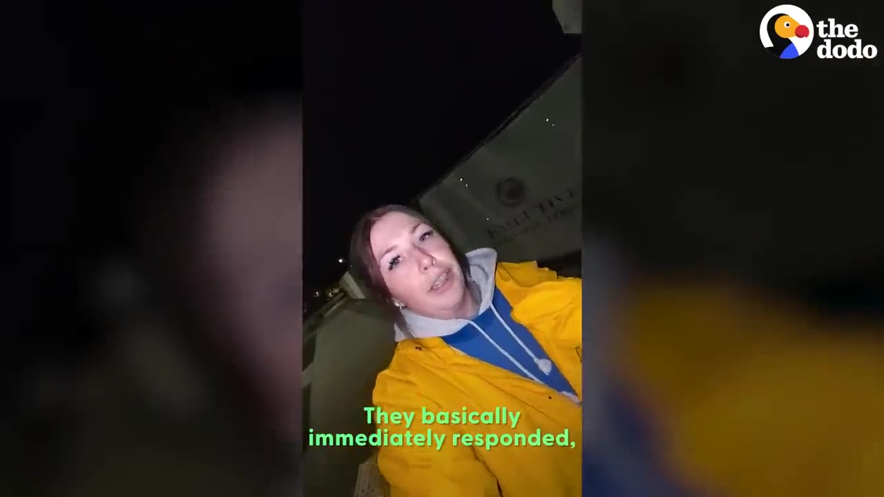 A woman wearing a yellow jacket looking at the camera outdoors at night while talking.