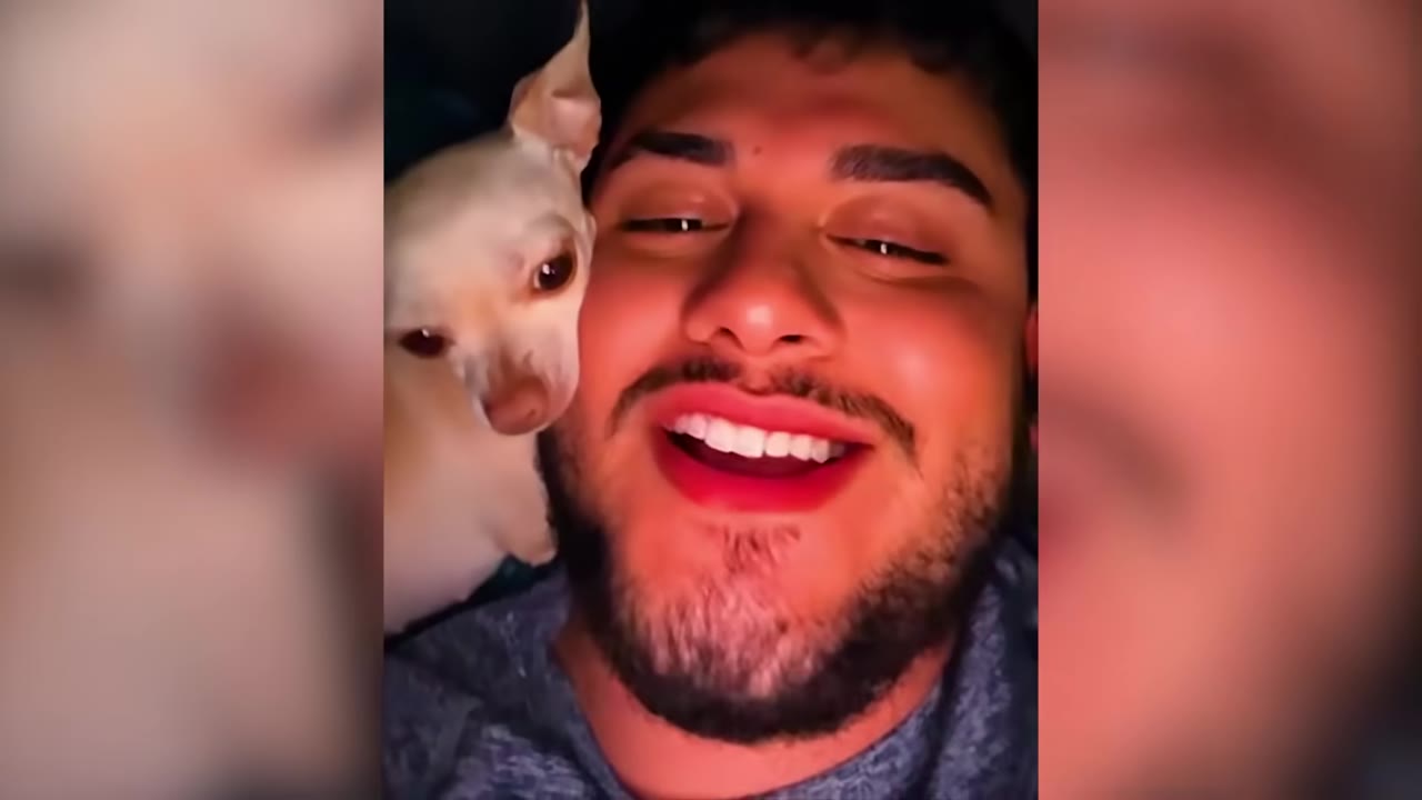 A man smiling with his small white Chihuahua resting near his face.