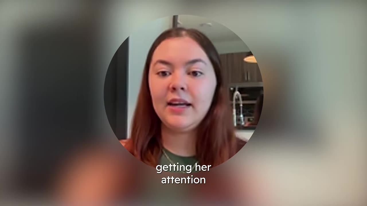 A woman with brown hair speaking in a circular frame overlay, with the text 'getting her attention' displayed at the bottom.