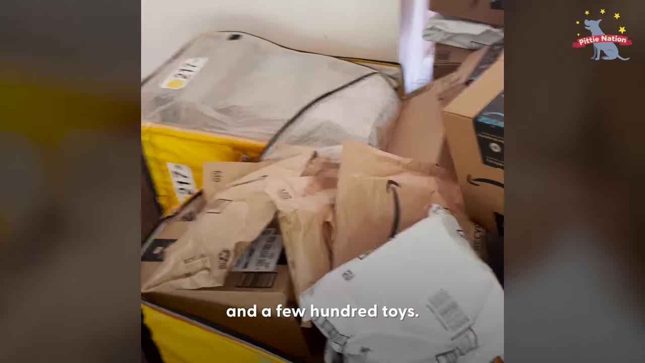 A large pile of delivery boxes and Amazon shipping envelopes stacked in a room.