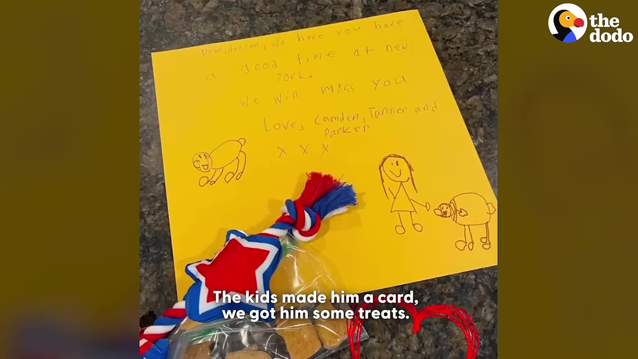 A yellow card written by kids that says 'Dear Duncan, We hope you have a good time at New York. We will miss you. Love, Camden, Tanner and Parker' next to a dog toy and treats.