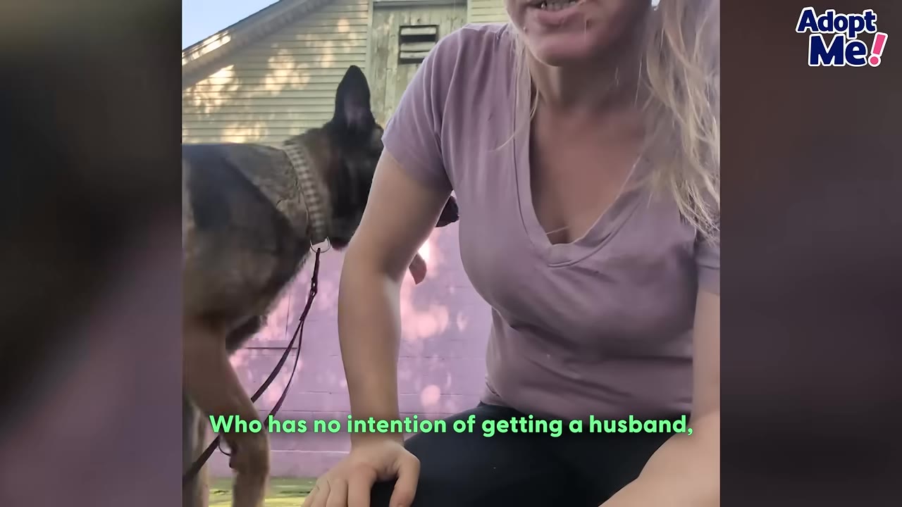 A German Shepherd dog wearing a collar and leash stands next to a woman in a purple shirt outdoors.