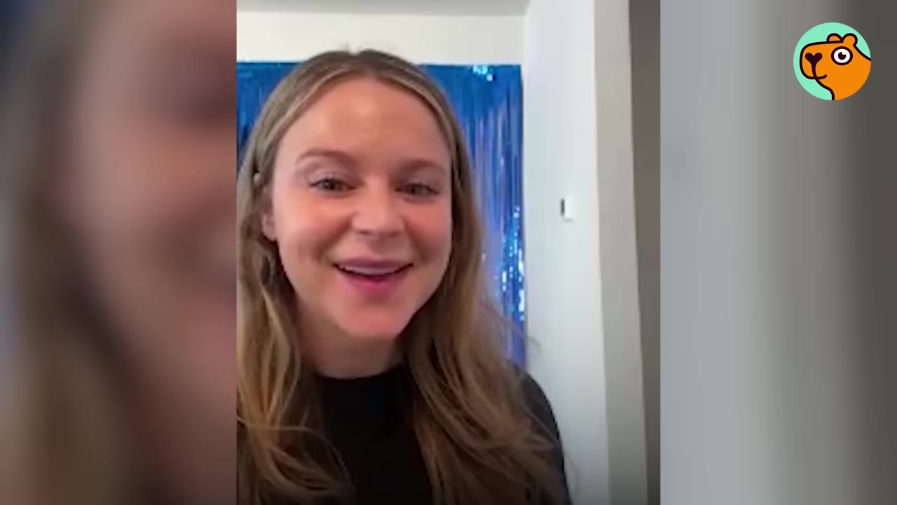 A woman with long blonde hair looking directly at the camera and smiling.