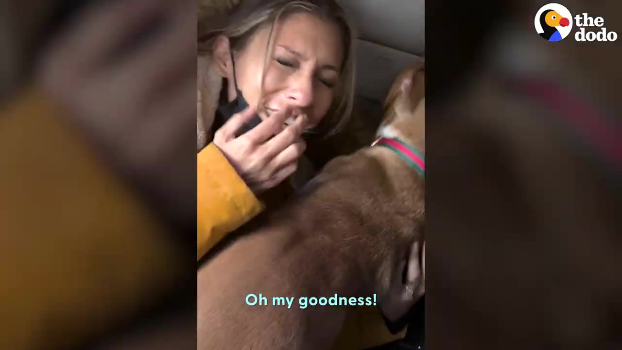 An emotional woman crying tears of joy while holding and comforting her dog close to her.