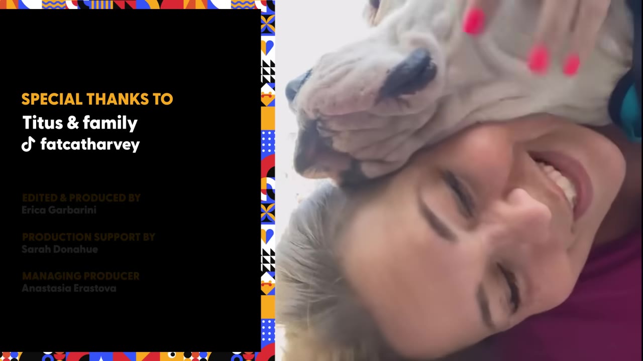A woman smiling warmly as a light-colored dog rests its head on hers.